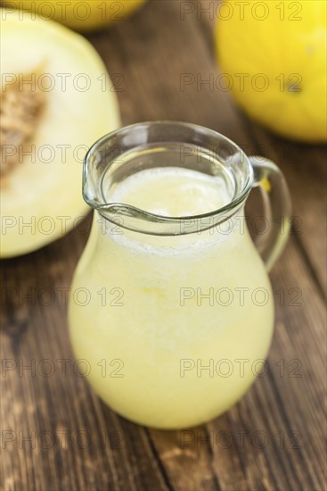 Healthy Honeydew Melon Smoothie (selective focus) on an old wooden table