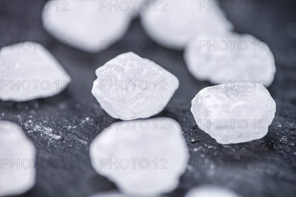 Slate slab with white rock sugar (selective focus, close-up shot)