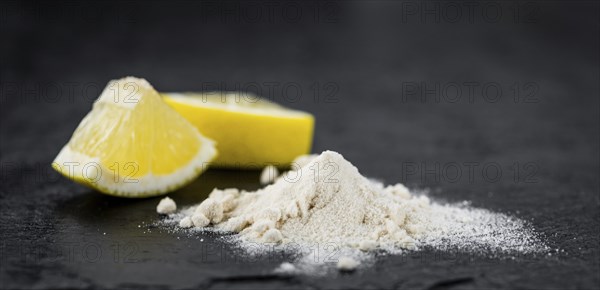 Some healthy Lemon powder on a vintage slate slab (selective focus)