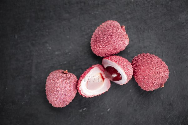 Portion of Litchis as detailed close up shot on a slate slab (selective focus)