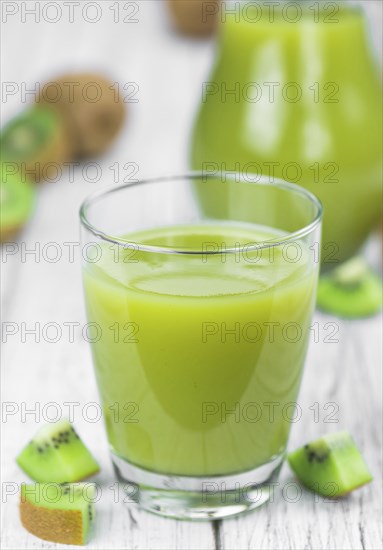 Kiwi Smoothie (selective focus) on an old and vintage background (homemade)