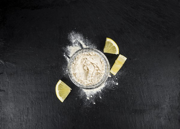 Some healthy Lemon powder on a vintage slate slab (selective focus)