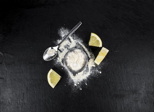 Portion of healthy Lemon powder on a slate slab (selective focus)