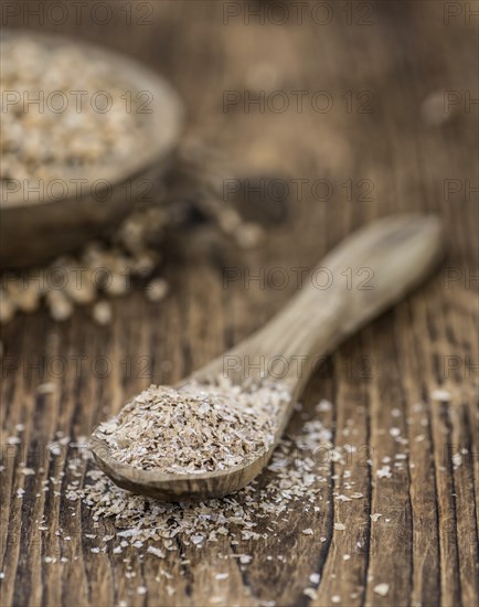 Wheat Bran on an old wooden table (selective focus)