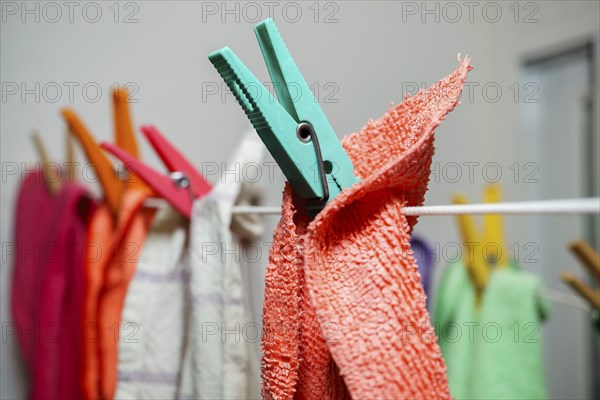 Different colored kitchen towels on a clothesline drying