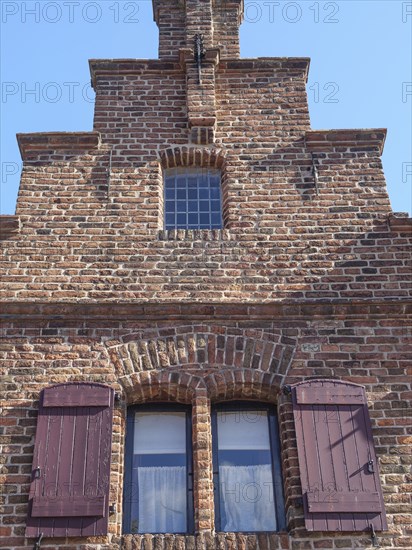 Close-up of a historic brick building with striking window sills and shutters, Doesburg, Netherlands