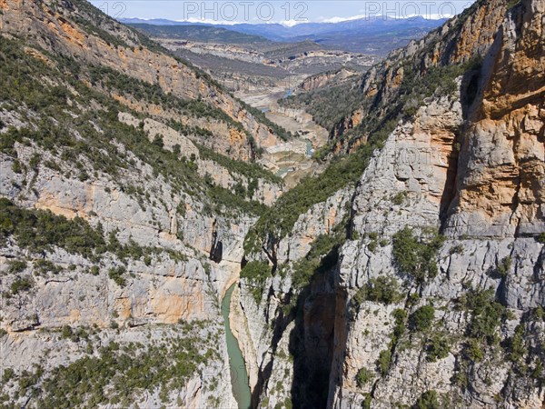 An aerial view of a rocky gorge in a mountainous environment with a river winding through rugged cliffs, aerial view, Congost de Mont-rebei gorge, Noguera Ribagorçana Mont-rebei Natural Park, Montsec mountain range, Noguera Ribagorçana river, Lleida province, Catalonia, Aragon, Spain, Europe