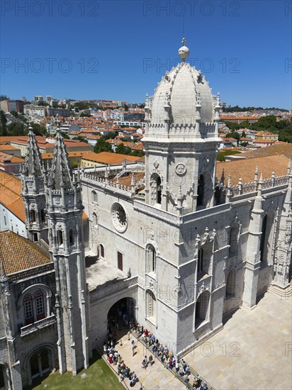 Large Gothic cathedral with high towers and a dome, surrounded by a cityscape under a blue sky, aerial view, Hieronymus Monastery, Mosteiro dos Jeronimos, Hieronymite Monastery, World Heritage Site, Monastery Church of Santa Maria, Belém, Belem, Bethlehem, Lisbon, Lisboa, Portugal, Europe