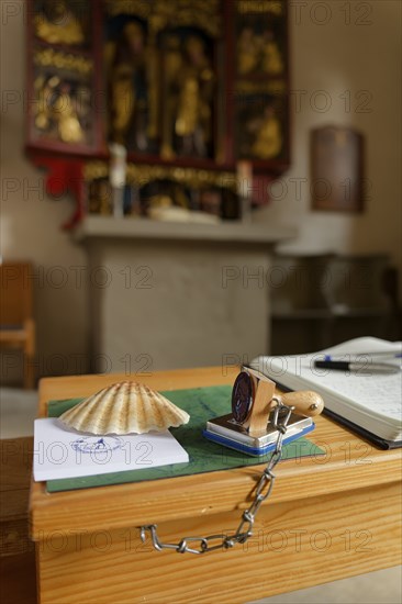 Pilgrim's stamp and pilgrim's guest book in the Wolfgangskirche, rose garden-Tullau, Tullau, scallop shell, Way of St James, pilgrimage, Kocher valley, Kocher, Schwäbisch Hall, Hohenlohe, Heilbronn-Franken, Baden-Württemberg, Germany, Europe