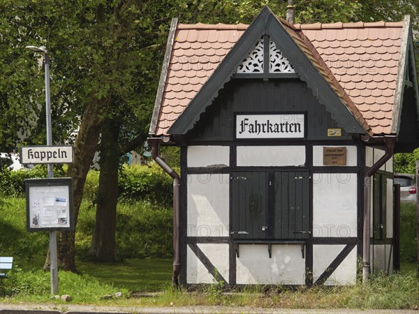 Small half-timbered building with signs and ticket office at an old railway station, Kappeln, Schleswig-Holstein, Germany, Europe