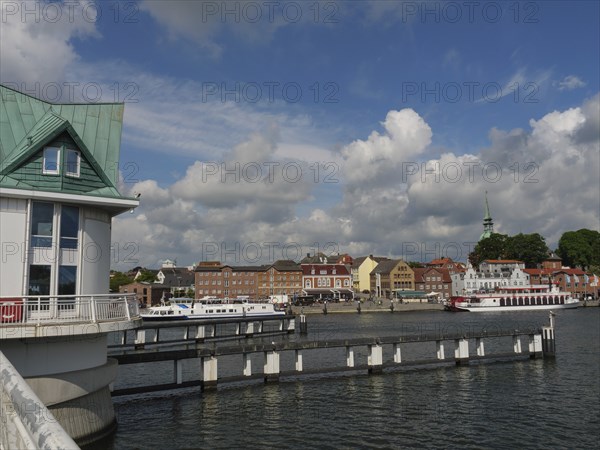 View of the town and harbour with boats and a bridge under a cloudy sky, Kappeln, Schleswig-Holstein, Germany, Europe