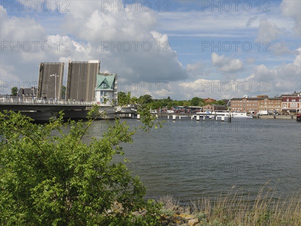 Open bridge over water in city scenery with clouds, Kappeln, SChleswig-Holstein, Germany, Europe