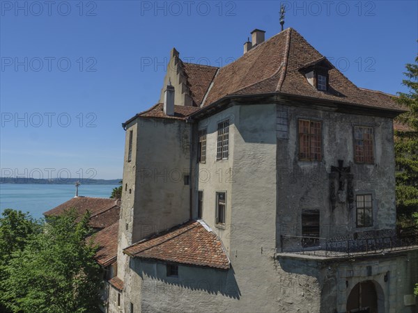 Castle overlooks a lake and is surrounded by trees, with historical details, Meersburg, Germany, Europe