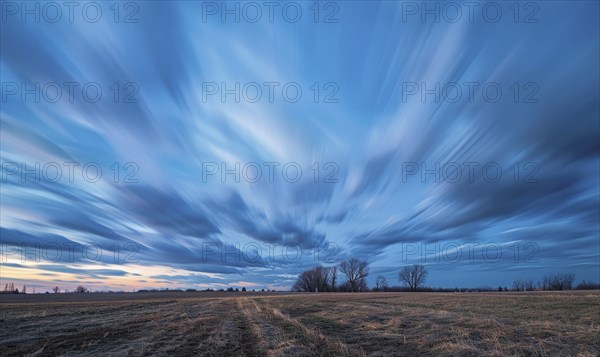 Bright blue sky, wispy cirrus clouds, windy evening AI generated