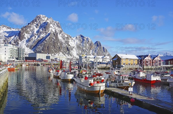 Harbour with boats and snowy mountains in the background, surrounded by a lively town and clear sky, Fishing, Lofoten, Svolvaer, Nordland, Arctic, Norway, Europe