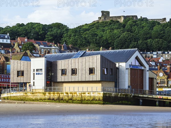 RNLI Scarborough Lifeboat Station and boat over Scarborough Beach, Scarborough, North Yorkshire, England, United Kingdom, Europe