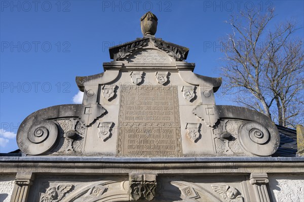 Detail of the entrance portal of the cemetery, since 1618, with volutes and coats of arms of the builders and tree moulding, Mainbernheim, Lower Franconia, Bavaria, Germany, Europe