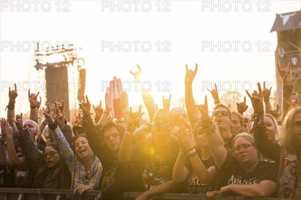 Festival-goers in the front row give the devil's salute at the Wacken Open Air in Wacken. The traditional metal festival takes place from 31 July to 3 August 2024