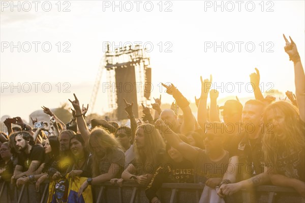 Festival-goers in the front row give the devil's salute at the Wacken Open Air in Wacken. The traditional metal festival takes place from 31 July to 3 August 2024