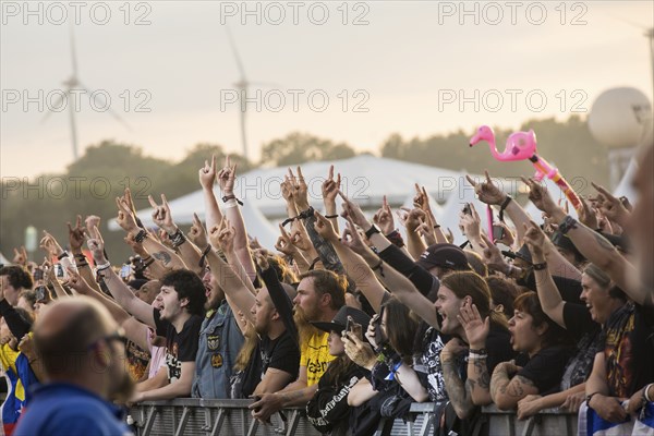 Festival-goers in the front row give the devil's salute at the Wacken Open Air in Wacken. The traditional metal festival takes place from 31 July to 3 August 2024