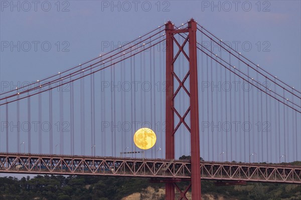 Full Moon and 25th of April Bridge. Lisbon, Portugal, Europe