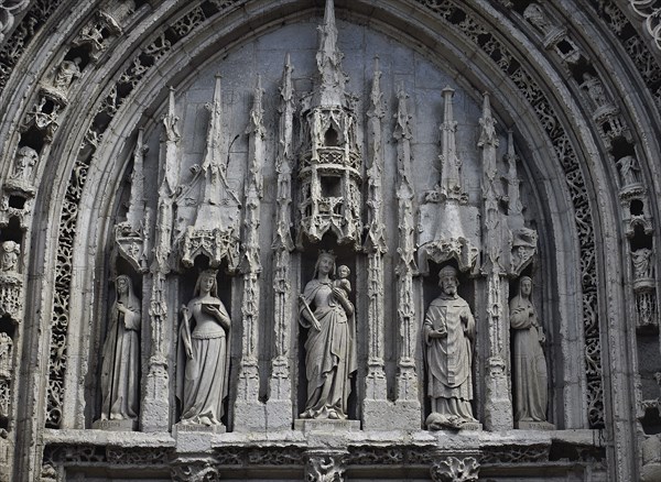 Tympanum at the Sainte Radegonde church (Poitiers, France) . Sainte Radegonde is 2th from left, Saint Hilaire 2th from right, the Virgin in the middle