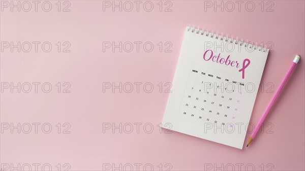 October calendar with a breast cancer awareness pink ribbon and a pencil with copyspace, AI generated