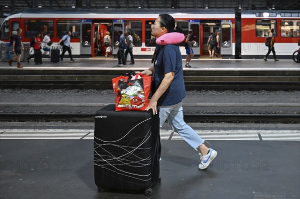 SBB railway station passer-by with trolley case