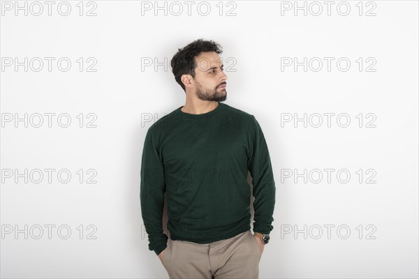 Portrait of a latin man looking to the side. White background