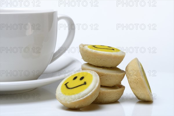 Pastry with smiley face and coffee cup, symbol