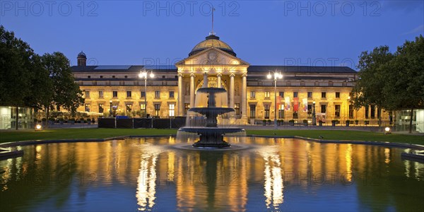 Illuminated spa hotel and Casino in the evening with cascade fountain, Wiesbaden, Hesse, Germany, Europe