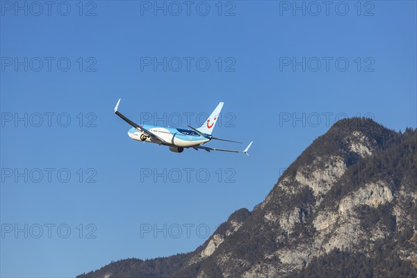 TUI airline aircraft taking off at Innsbruck Kranebitten Airport, Boeing 737-800. Snow-covered mountains of the Alps, Innsbruck, Tyrol, Austria, Europe