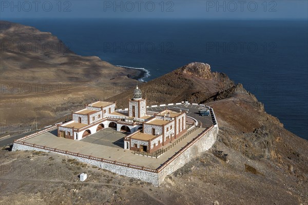 Bird's eye view of aerial view of building complex of lighthouse Faro de la Entallada from 50s year 1953 1954 with large glass dome on 183 metres high cliff, behind it steep coast and Mirador de Entallada, Las Playitas, Tuineje, Las Palmas, Fuerteventura, Canary Islands, Spain, Europe