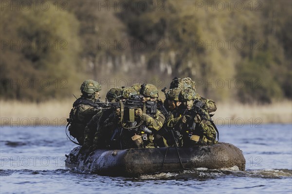 Czech and German soldiers launch an inflatable boat into the Elbe as part of the military exercise 'Wettiner Schwert' near Tangermünde, 26 March 2024. 'Wettiner Schwert' is part of the NATO Quadriga exercise