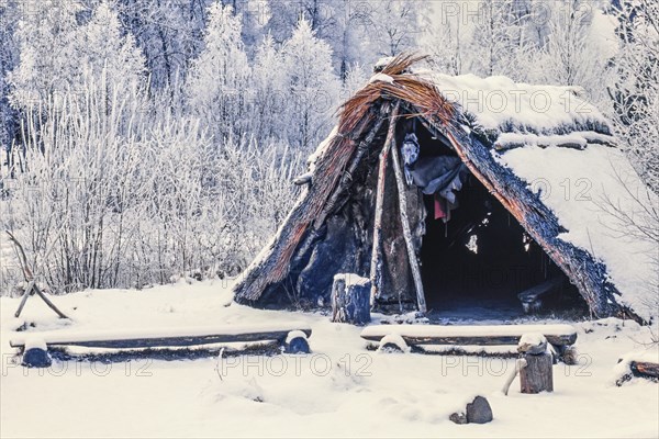 Reconstruction of a Stone Age hut made of reeds in a snowy winter landscape, Sweden, Europe