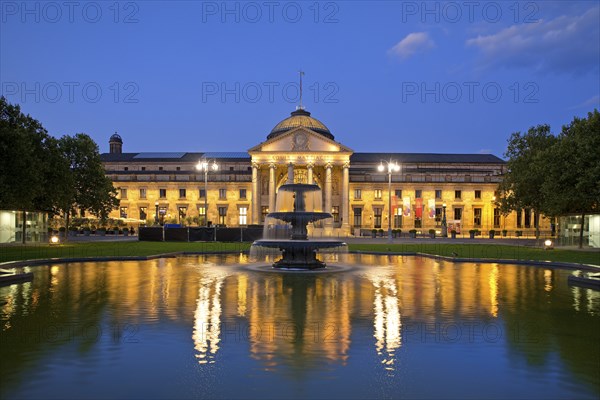 Illuminated spa hotel and Casino in the evening with cascade fountain, Wiesbaden, Hesse, Germany, Europe