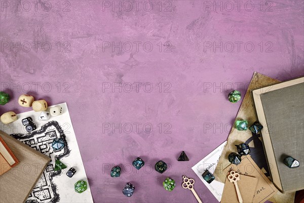 Tabletop role playing flat lay with colorful RPG dices, rule books, dungeon map on purple background with copy space