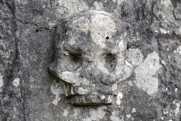 Chiselled skull as decoration on an old weathered gravestone, Kilmartin, Argyll and Bute, Scotland, Great Britain