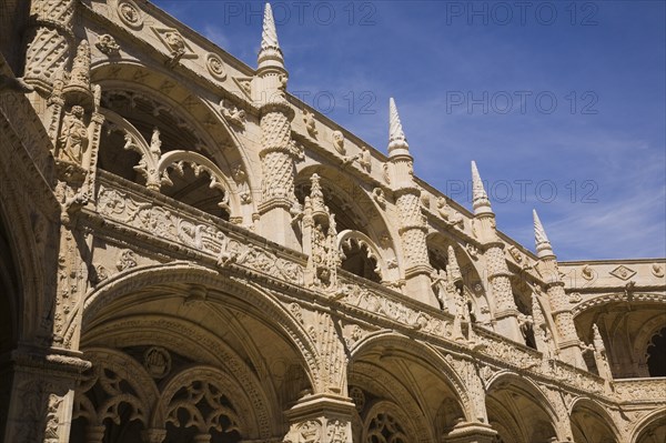 Old architectural building with arches and carved decorative sculptures in the inner courtyard at Jeronimos Monastery, Lisbon, Portugal, Europe