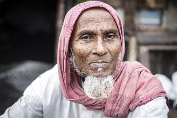 Man in front of his house, Tejgaon Slum Area, Dhaka, Bangladesh, Asia