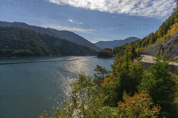 Intake structure at the Sylvenstein reservoir is used for flood protection, dams the Isar, power station, power generation, forest, road, blue sky