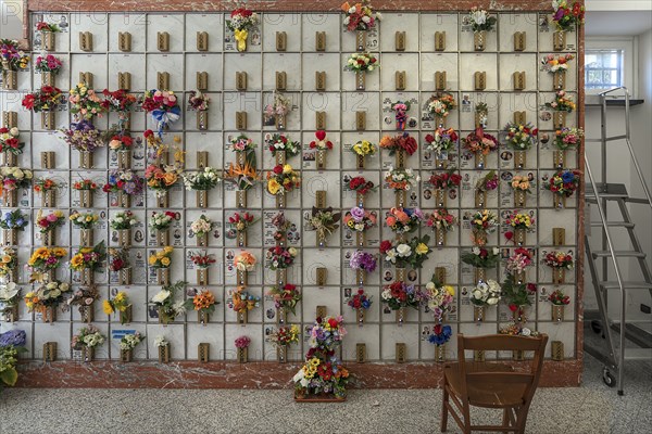 Urn graves with floral decorations in a hall at the Monumental Cemetery, Cimitero monumentale di Staglieno), Genoa, Italy, Europe