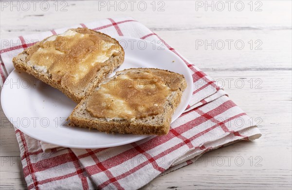 Sandwiches with pollock roe on a white plate, on a white wooden background with copy space