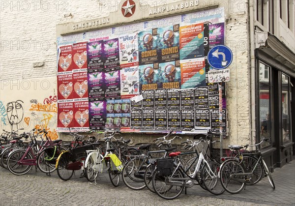 Cycles by colourful event posters on noticeboard, Maastricht, Limburg province, Netherlands