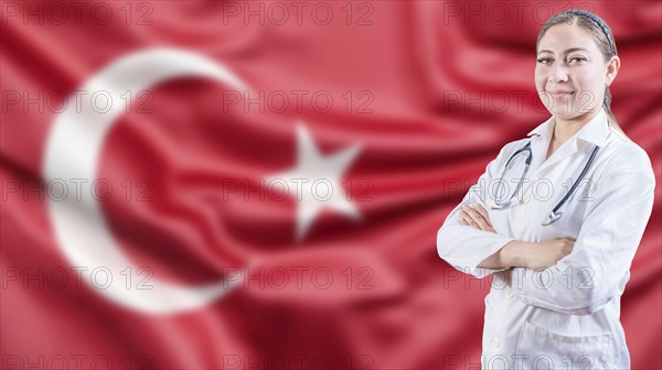 Portrait of doctor with crossed arms with Turkish flag in the background. Healthcare concept with Turkish flag in background