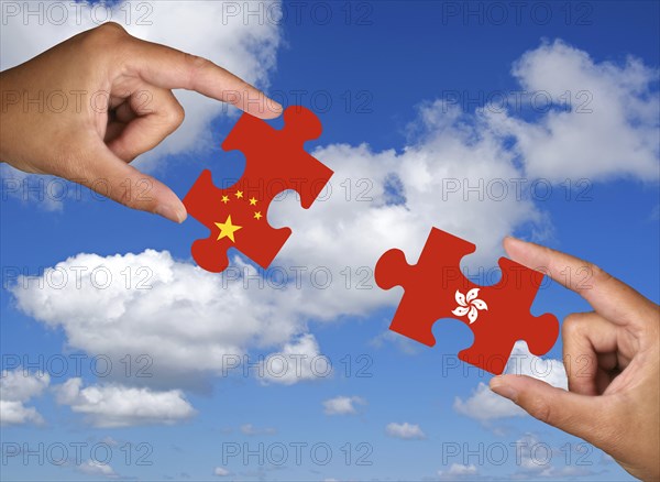 Puzzle pieces, Two hands each holding a puzzle piece, Hong Kong, China, Colony, Conflict, Economic crisis, Studio, Asia