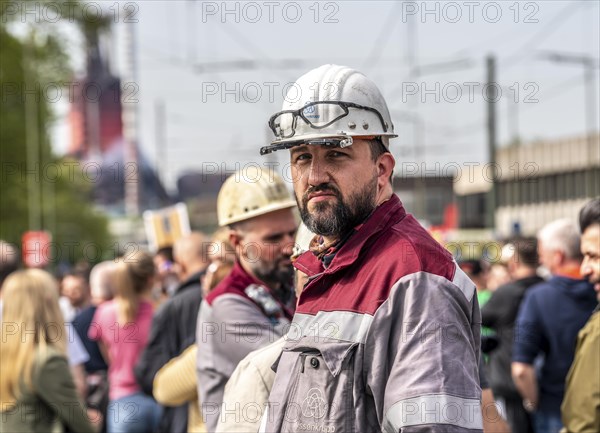 Steelworkers at a demonstration in front of the headquarters of ThyssenKrupp Steel Europe in Duisburg, against massive job cuts, after the participation of a foreign investor in the group, in the background the blast furnaces 8 and 9, Duisburg North Rhine-Westphalia, Germany, Europe