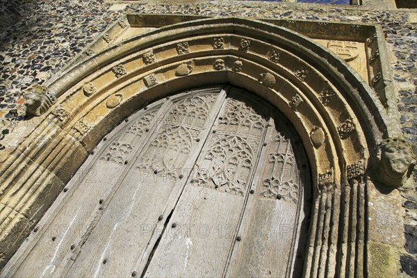 Carved stone wooden doorway arch, Church of All Saints, Brandeston, Suffolk, England, UK