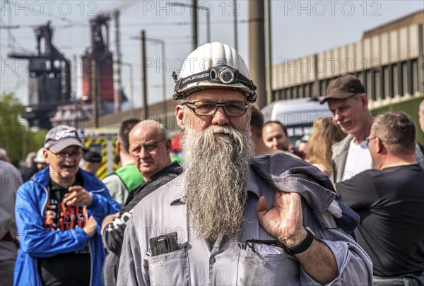 Steelworkers at a demonstration in front of the headquarters of ThyssenKrupp Steel Europe in Duisburg, against massive job cuts, after the participation of a foreign investor in the group, in the background the blast furnaces 8 and 9, Duisburg North Rhine-Westphalia, Germany, Europe