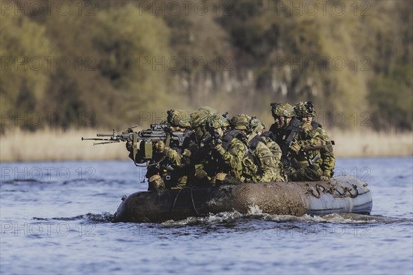 Czech and German soldiers launch an inflatable boat into the Elbe as part of the military exercise 'Wettiner Schwert' near Tangermünde, 26 March 2024. 'Wettiner Schwert' is part of the NATO Quadriga exercise